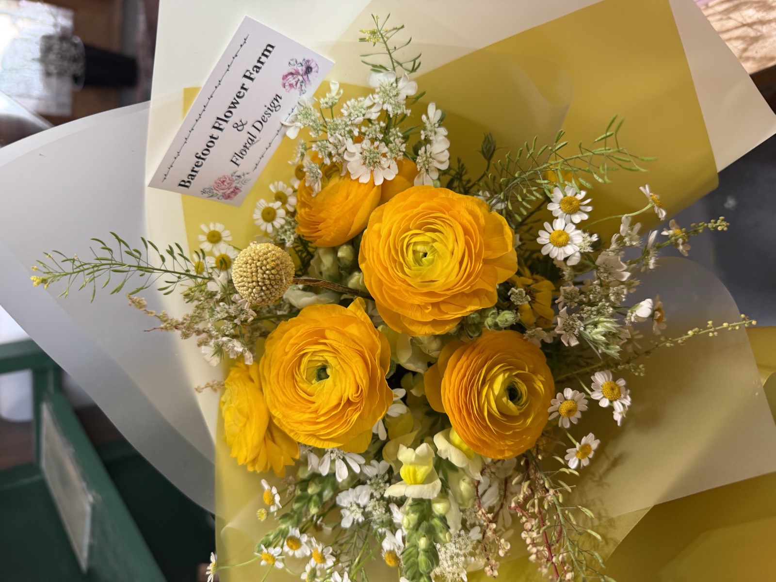 Sunshine yellow ranunculus bouquet with Barefoot Flower Farm branded card