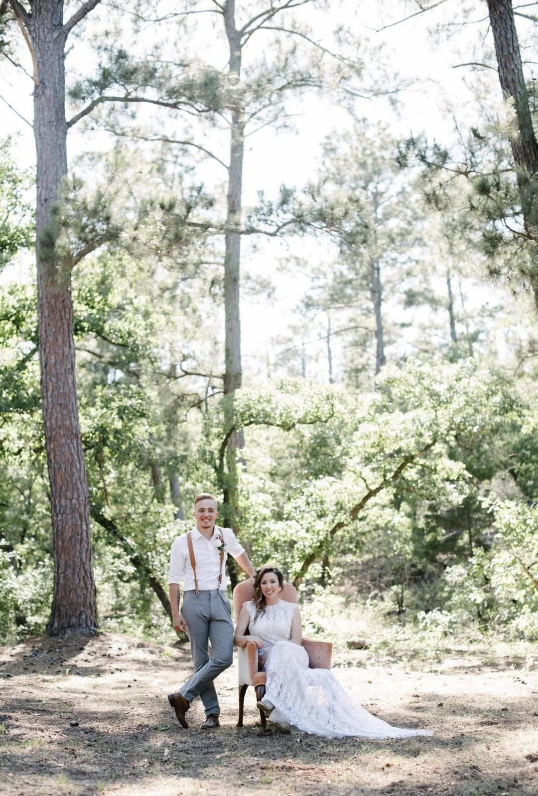 Bride and groom portrait in sunlit pine grove